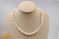 Elegant baroque freshwater pearl necklace in milky white on a beige velvet display bust - 8-9mm Baroque Pearl Necklace