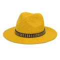 Detailed close-up of straw sun hat featuring decorative black band with silver square studs - M (56-58cm) / Yellow