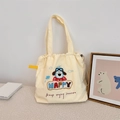 Detail van schattig hondenborduurwerk en Happy-tekst op een beige canvas trekkoordtas - Piloot Hond