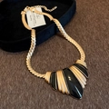 Macro detail of vintage gold snake chain necklace with black enamel fan pendant - 14# Necklace - Gold - Black Fan Snake Bone Chain