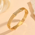Detailed close-up of a gold-plated titanium steel bracelet with three-layer zircon crystals - Gold Multi-Layer Gear Style (M713)