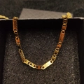 Close-up of golden stainless steel cable chain necklace inside a black jewelry box - Necklace 10