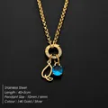 Gold stainless steel necklace with letter Q charm and round blue gemstone pendant detail - Letter Q
