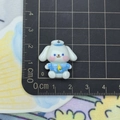 Macro shot of a cartoon dog figurine in sailor suit on a measuring mat for size reference - Dog Captain
