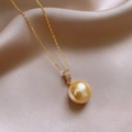 Close-up of golden pearl cross necklace with pavé zircon setting on silk background - Gold Pearl Diamond Pendant Style (14#)