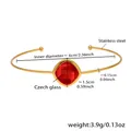 Minimalist gold stainless steel open bangle featuring a faceted red Czech glass gemstone - Gold/Red Stone
