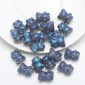 Detailed macro view of a 3D dark blue pearlescent bear crystal pendant for DIY jewelry - Frosted Ink Blue Plated