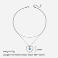 Double-layered silver necklace with blue heart pendant shown in a minimalist flat lay - Steel