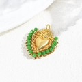 Detailed macro view of heart pendant with gold center and green faceted beads - Green Beads/Gold