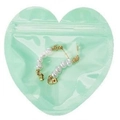 White pearl earrings in a mint green heart-shaped pouch with gold metal accents - Green