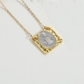 Detailed close-up of retro square pendant with silver relief on gold hammered frame - Square King (Silver)