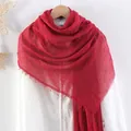 Solid bright red cotton linen scarf with frayed edges shown on a wooden hanger - Red
