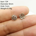Macro shot of 8mm silver flower spacer beads with detailed hollow floral patterns - Style 13