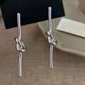 Polished silver knot tassel drop earrings on black jewelry display card with warm background - Knot Threader (Real Gold Plated) / Silver