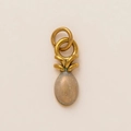 Macro shot of gold stainless steel heart pendant with glitter milky white gemstone - Clear Pineapple Charm
