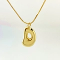 Polished golden necklace featuring a trendy balloon bubble bean pendant on box chain - Letter D / Gold