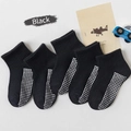Five pairs of black anti-slip cotton socks for children with white grip dots on soles - Solid Color Mesh With Adhesive Coating [black]