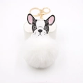 Detail of a fluffy white faux fur pompom French Bulldog bag charm with gold clasp - White