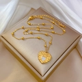 Goldene Herz-Halskette mit MOM-Anhänger und Strass auf beiger Schmuckschatulle - Titanstahl / Gold Herz MOM Stil (M418)