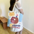 Off-white canvas tote bag featuring a colorful cartoon bear and Joyful text print - Flower Pot