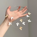 Three-layer steel wire necklace with matte gold and silver butterfly pendants in detail - 3-Layer Gold & Silver Butterfly