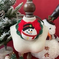 Close-up of knit Christmas pet bib with snowman patch on festive red background - One Size / Christmas Snowman (Red and Green)