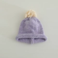 Detail of lavender knitted hat showing soft wool texture and a cream faux fur pom-pom - 3-8 Years / Purple (Off-white Pom)