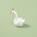 Detailed view of mini white resin swan pendant with orange beak and silver metal loop - Swan