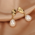 Detail of 18K gold-plated earrings with drop-shaped freshwater pearls on satin background - ER1468-A Lava Texture Waterdrop Pearl