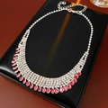 Detail of silver drop necklace with pink and clear rhinestones on black display box - Pink