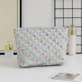 Quilted floral toiletry bag shown in a lifestyle setting with cosmetic accessories - Large Capacity / Green Plaid Floral