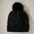 Detailed view of black beanie with silver metallic thread and large faux fur pom-pom - Black