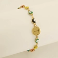 Gold evil eye charm bracelet featuring multi-color beads and letter T round pendant - Letter T