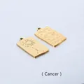 Detail of gold Cancer zodiac rectangular pendant with sun and moon pattern on metal - Cancer