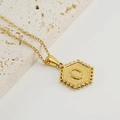 Golden stainless steel necklace featuring a hexagonal letter O pendant with beaded edges - Letter O (Single Pendant)