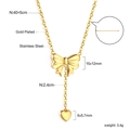 Detail of gold bow necklace with heart pendant and lobster clasp on white background - Bowknot Heart Drop Necklace