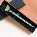 Close-up of a silver crystal ballpoint pen with yellow raw stone in a black gift box - Citrine
