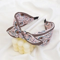 Pink bohemian floral fabric headband with bow and dark brown edges on white cloth - Pink Paisley Print Bow Headband