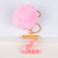 Detail of pink faux fur pompom and resin letter Z keychain with gold leaf and shell flakes - Letter Z