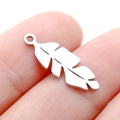 Single silver feather charm in stainless steel shown on a finger for scale and detail - DY746 Feather / Steel