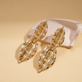 Elegant gold leaf dangle earrings with textured vein patterns and polished metallic finish - Stainless Steel Post - Gold