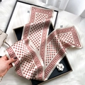 Beige 100% silk skinny scarf with red horseshoe pattern held by hand on a tray - Horse Bit-Orange