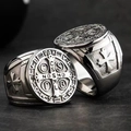 Macro shot of retro stainless steel St. Benedict medal ring with religious cross relief - Silver