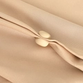 Beige magnetic hijab clip secures pleated light brown fabric with stylish minimal design - Beige