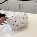 White quilted cosmetic bag with red heart pattern and pink bow decorative detail - White Heart