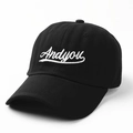 Close-up of black cotton baseball cap featuring white Andyou cursive letter embroidery - Adjustable / Black