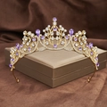 Detail of a golden Baroque crown with purple water drop gems and sparkling rhinestones - Gold with Purple Zircon