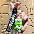 Green cartoon frog silicone keychain with a pink flower and golden lobster clasp - Sanrio Airplane-Keroppi