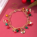 Detailed shot of Christmas charm bracelet with enamel deer, bells and socks on red festive background - D1145 (Red Green Bell Reindeer)