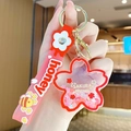 Pink Sakura festival floating charm keychain with red honey silicone wrist strap - Sakura - Red